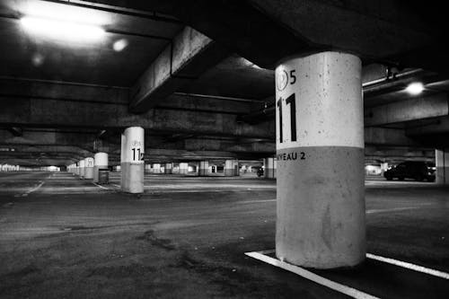 Grayscale Photography of Parking Area in the Building