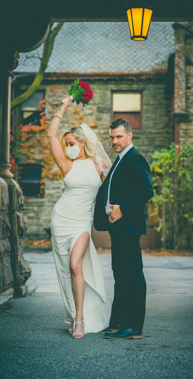 Bride In Protective Mask Near Elegant Groom In Formal Suit