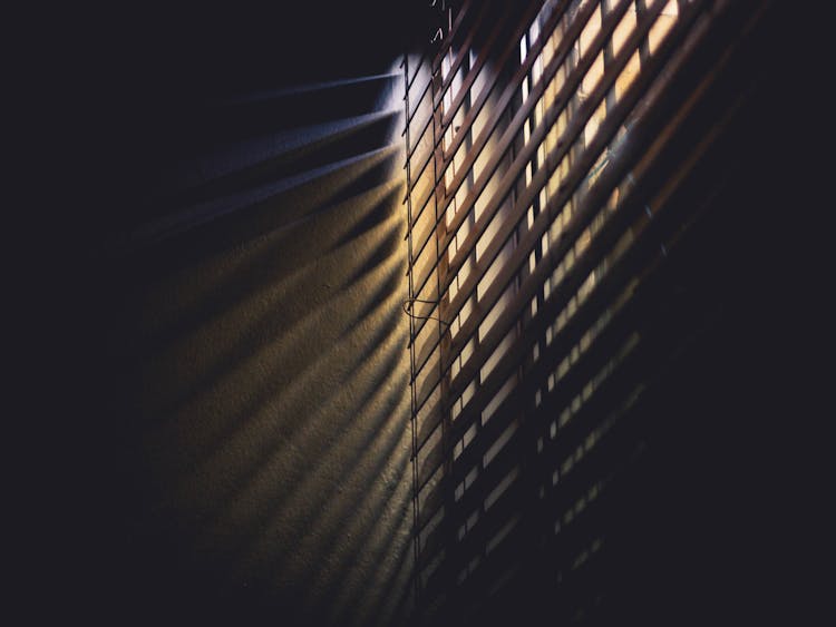 Low Light Photography Of Brown Window Blinds