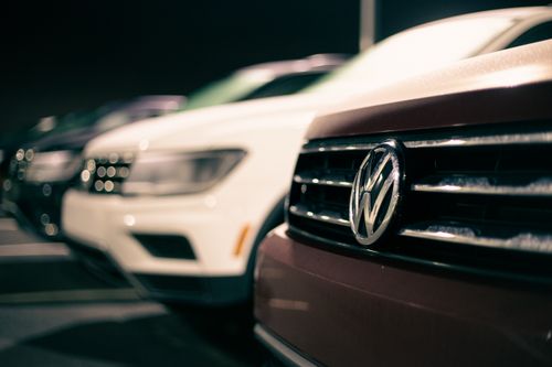 Free Front bumpers of expensive prestige automobiles at market retailing new cars at night Stock Photo