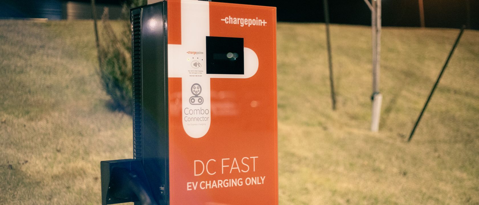 Electric recharging point for vehicles working on eco friendly energy source against hill on roadside at night