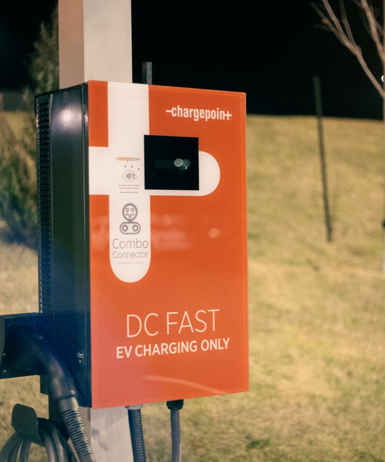 Electric recharging point for vehicles working on eco friendly energy source against hill on roadside at night