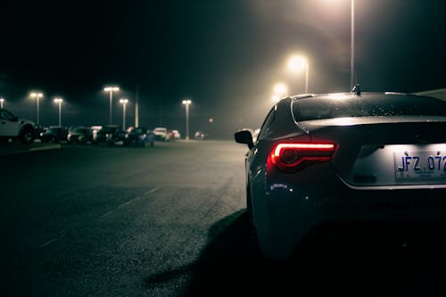 Sports car with luminous taillights on parking lot