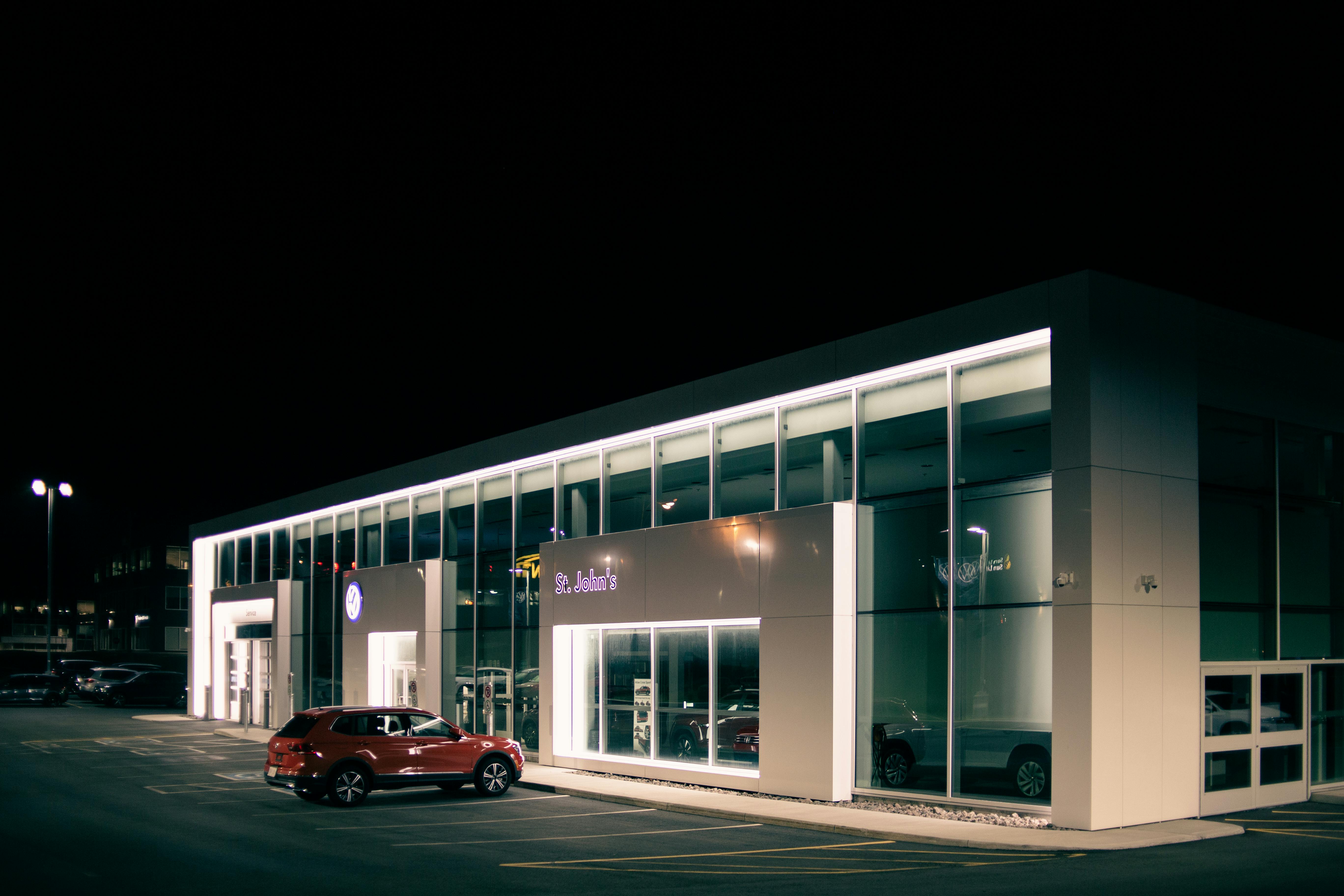 modern car parked near building with glowing lights