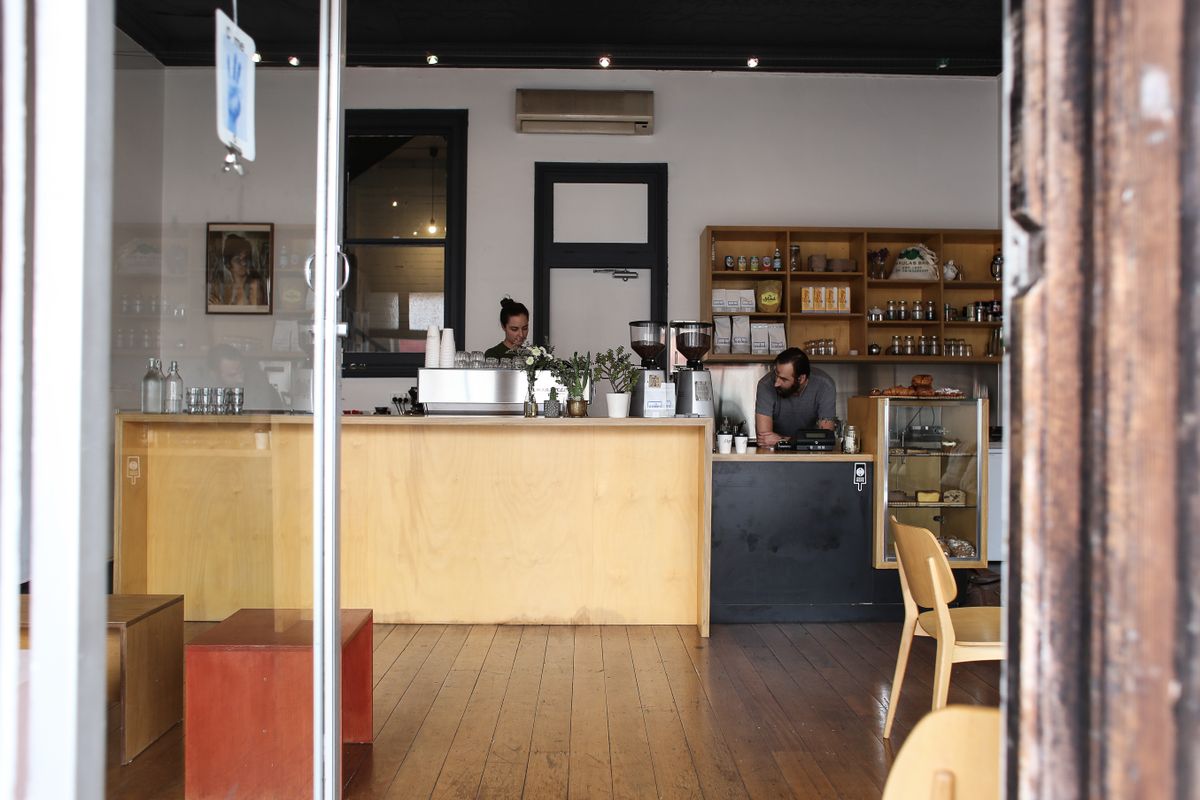 Modern cafe counter with workers preparing for service