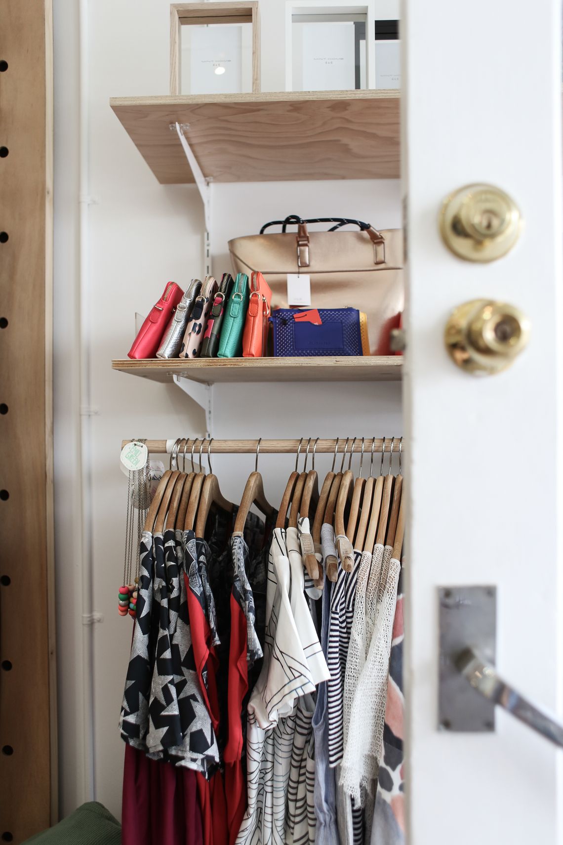 Elegant organized wardrobe with clothing handbags and shelf storage