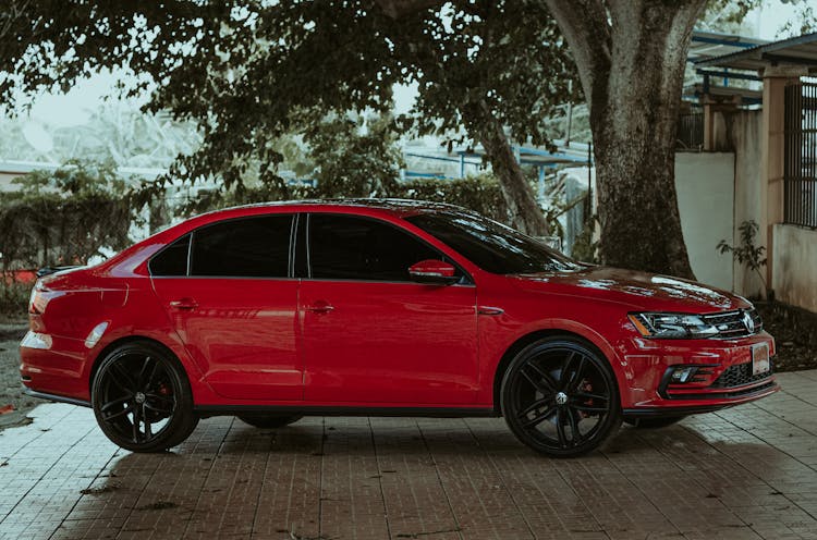 Red Sedan Car In The Car Park