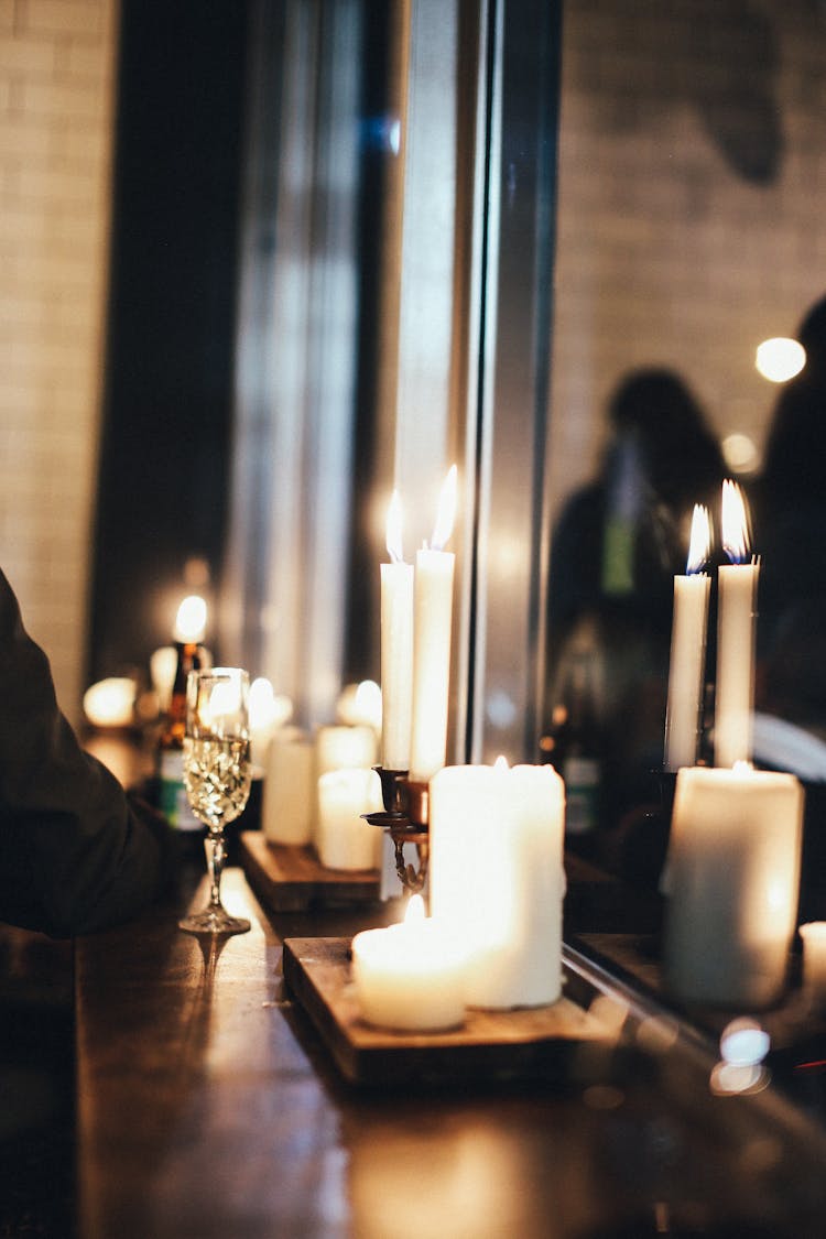 Lit Candles Lined Up On Windowsi