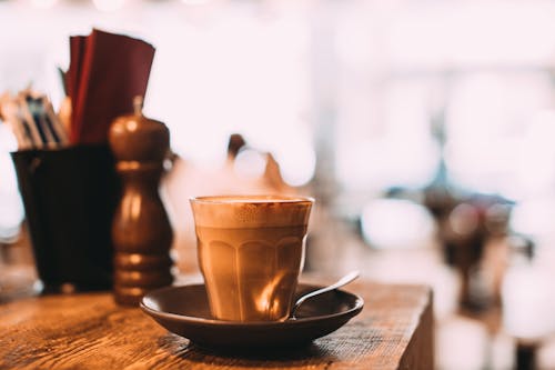 Free Close-Up Shot of a Glass of Coffee on a Saucer Stock Photo