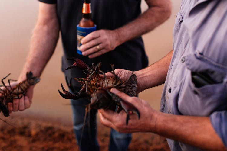 Men Holding Crayfish