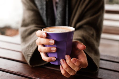 A Person Holding Purple Ceramic Mug