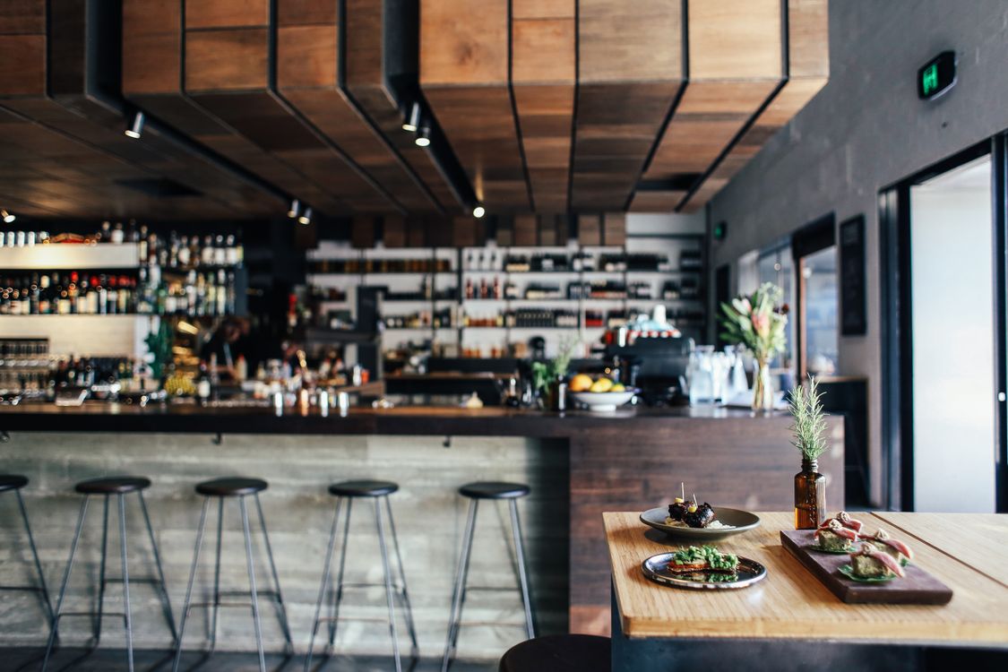upscale restaurant dining room interior with warm lighting and table settings