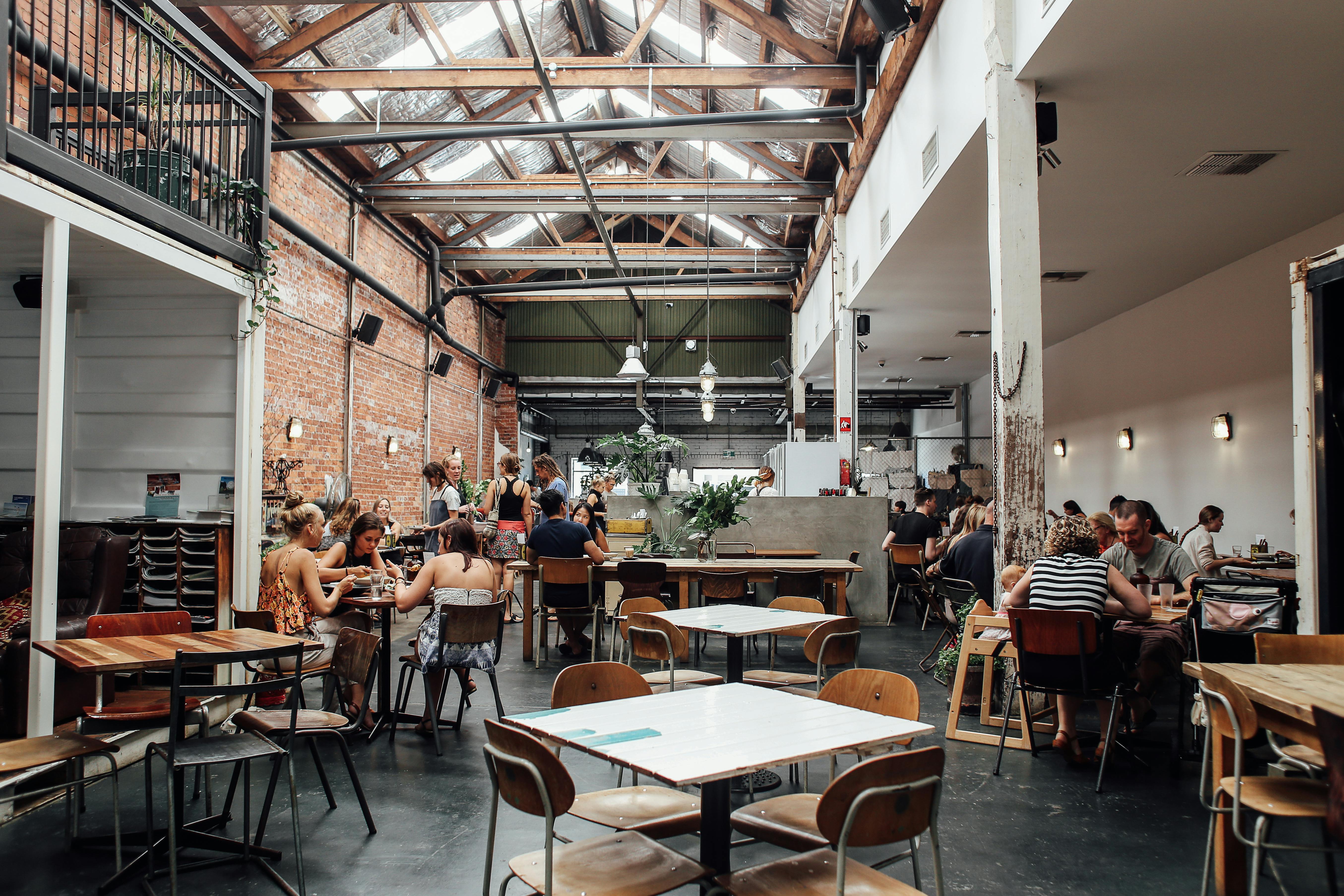 People sitting on chairs inside the restaurant. | Photo: Pexels