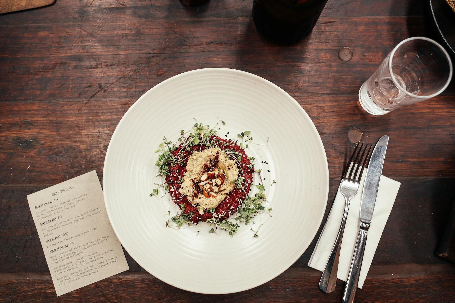 Gourmet Meal on a Plate and a Menu on a Restaurant Table