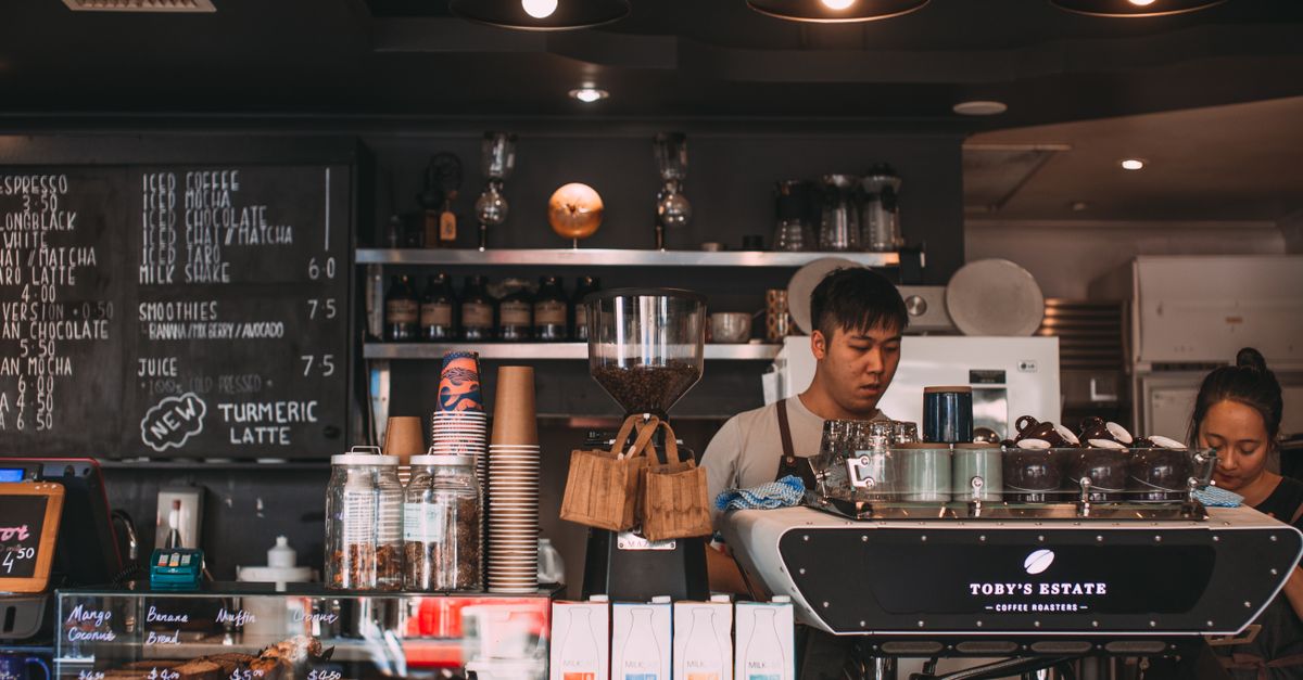 teenager working part-time job at a cafe interacting with customers