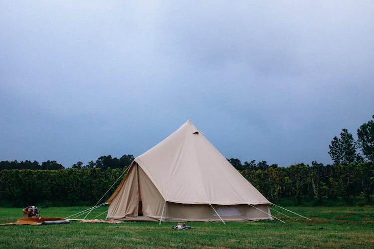 Brown Tent On Green Grass Under Blue Sky