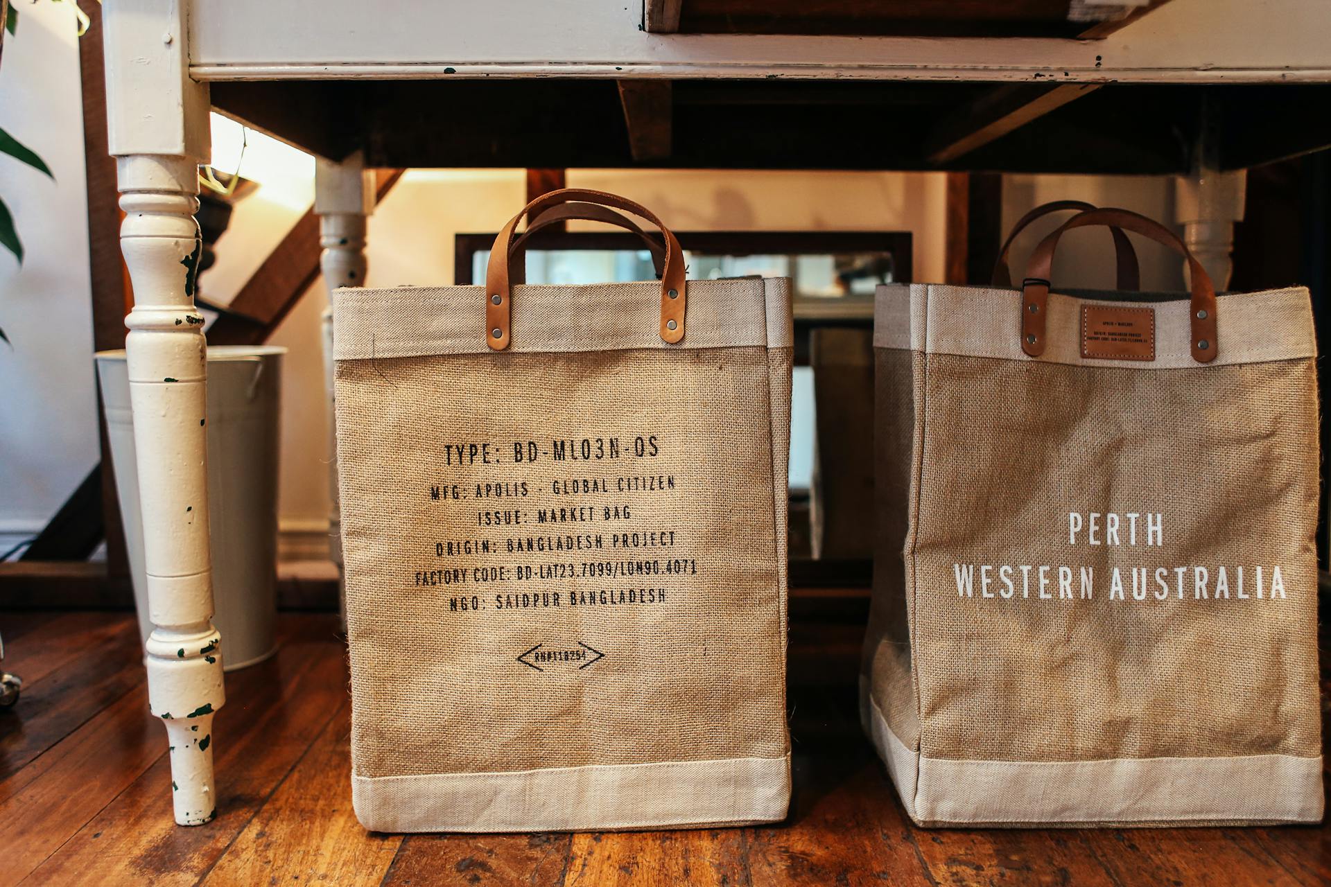 Sustainable burlap shopping bags on a vintage wooden floor enhance eco-friendly living choices.