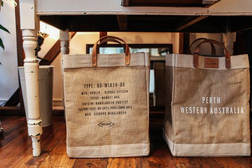 Burlap shopping bags on wooden floor