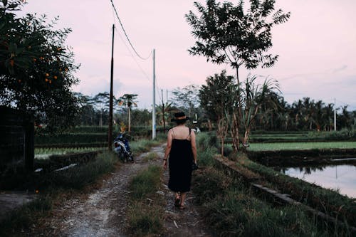 Woman Walking on a Pathway