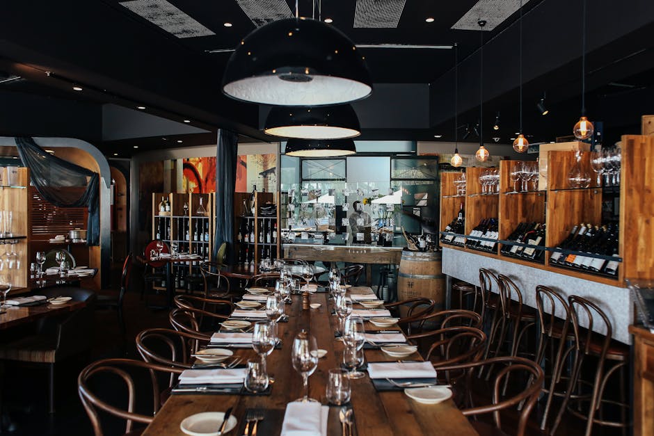 Stylish restaurant interior with wooden decor and table settings for a cozy dining experience.
