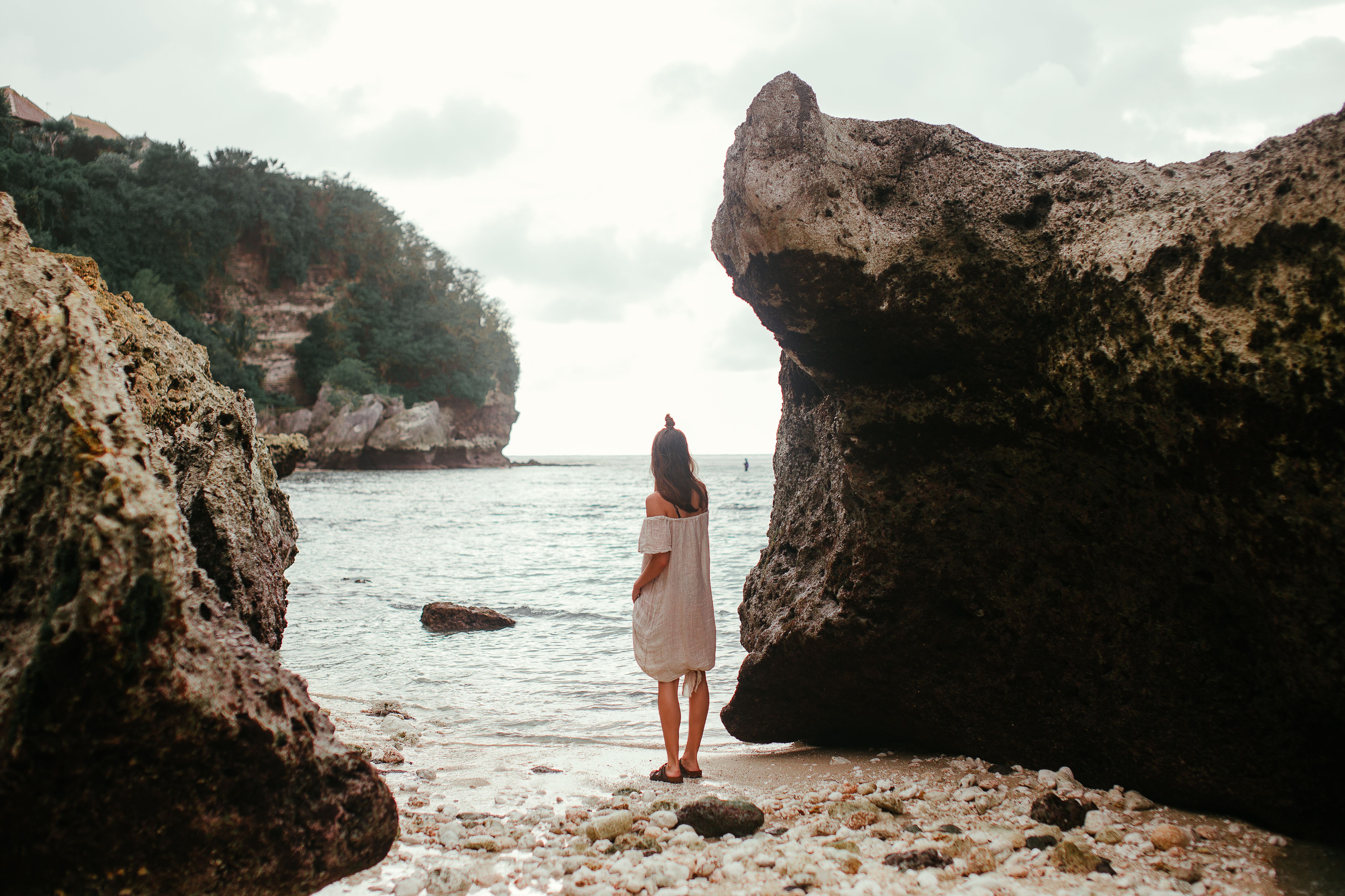 Woman in White Dress Standing Near Rock Formation · Free Stock Photo