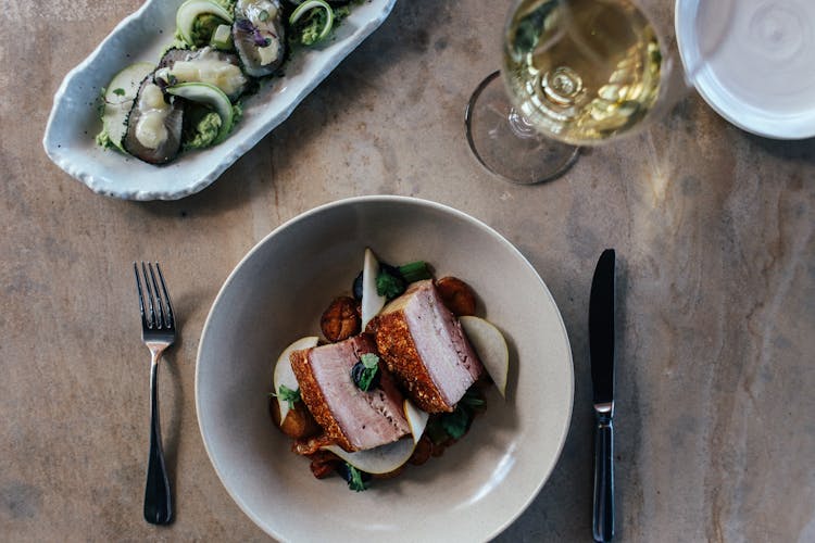 Meat Meal And White Wine On Table