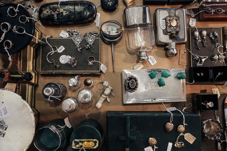 Vintage jewelry and antiques displayed at an estate sale market