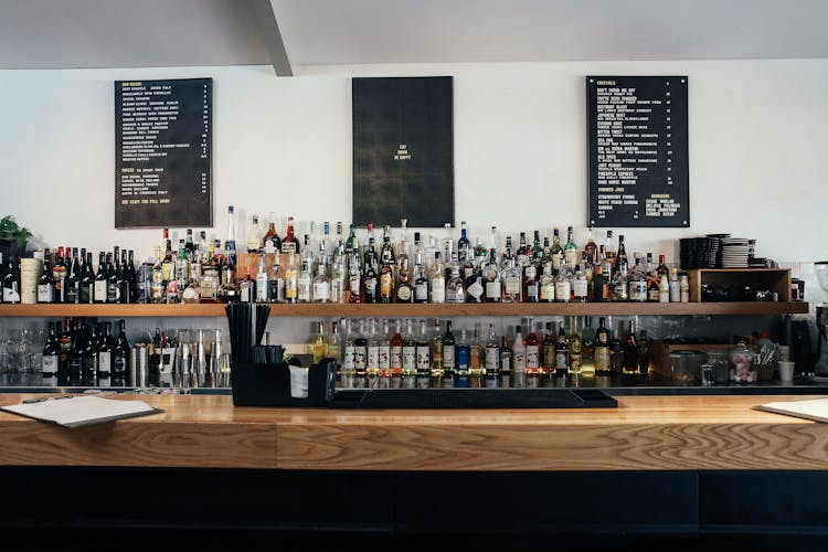 Liquor And Wine Bottles On Shelves Of A Bar