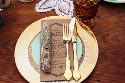 Golden Fork and Bread Knife on Ceramic Plate