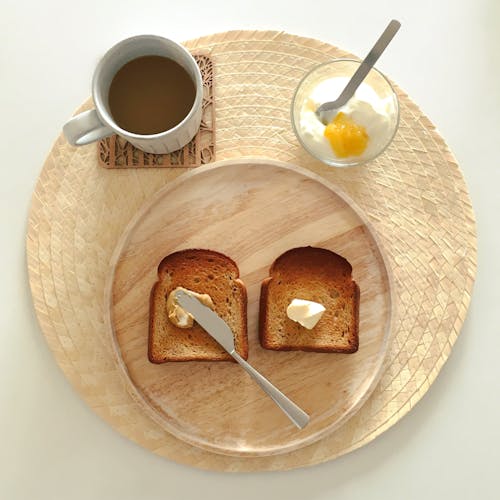 Wooden Plate with Butter and Toast Coffee on the Side