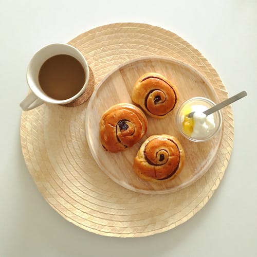 Cup of Coffee with Breads and Yogurt on Wooden Plate