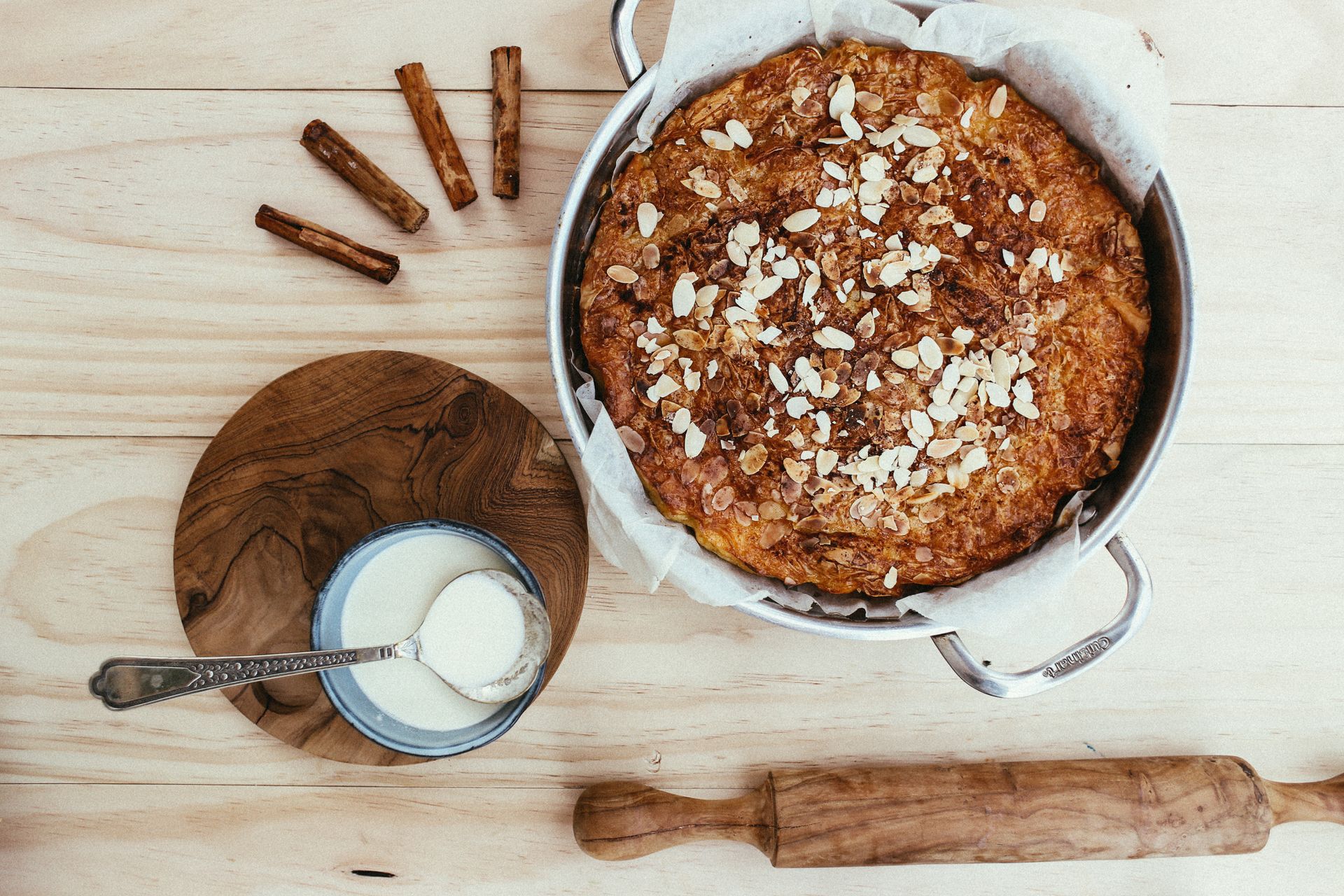 Freshly Baked Cinnamon Cake with Almonds on Top Wooden Background