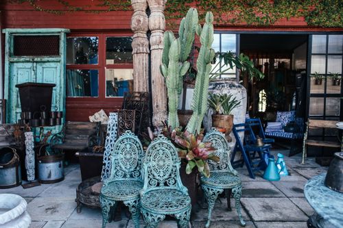 Free Eclectic vintage patio scene with retro furniture, plants, and unique decor items. Stock Photo
