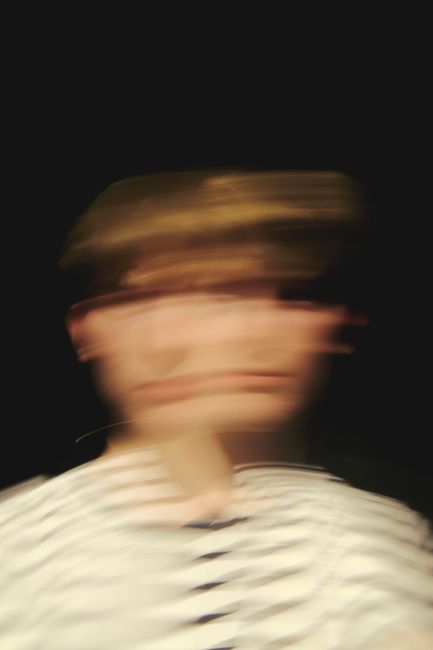Ethereal portrait of a person with blurred motion, conveying dynamic movement.