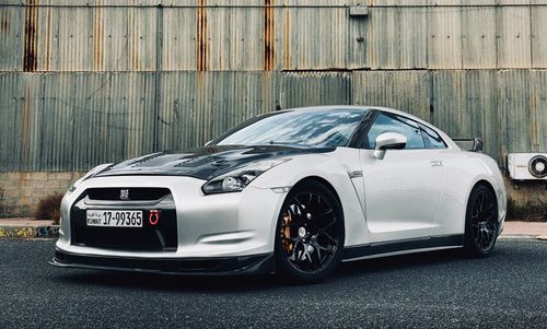 Free Silver and black sports car parked outdoors in Kuwait City, showcasing sleek design. Stock Photo