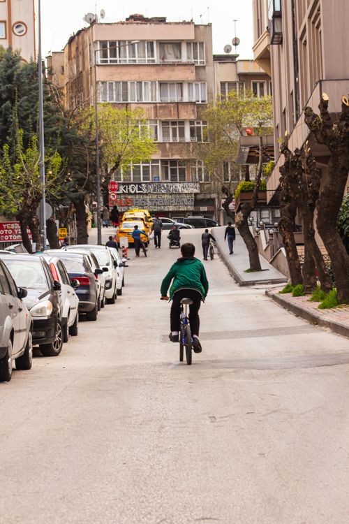 Free A child riding a bicycle on a busy urban street in Gaziantep, Turkey. Stock Photo