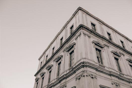 A grayscale image capturing the intricate facade of a historic building in Istanbul. Low angle shot.