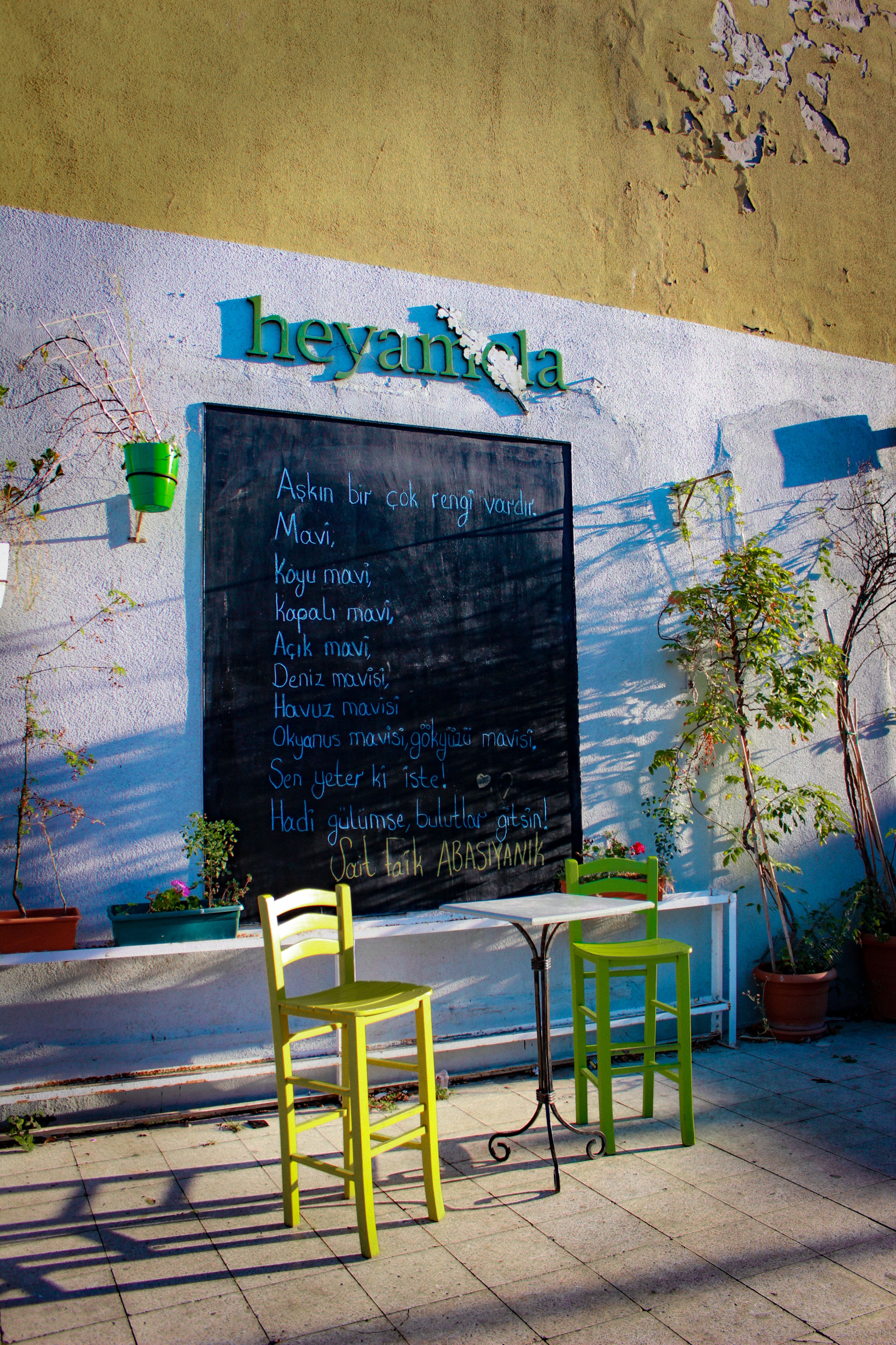 Brightly colored chairs at a quaint café in Heybeliada, showcasing poetic elegance.