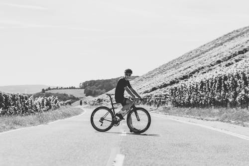Free Black and White Photo of Man on a Bicycle Stock Photo