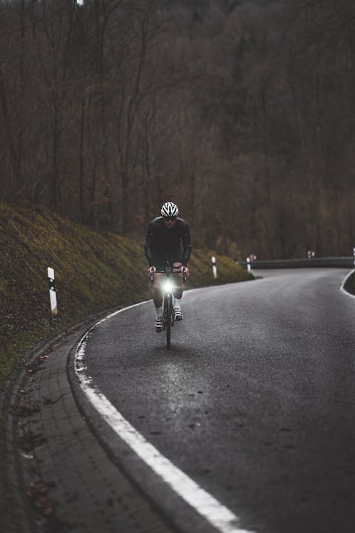 Free A Man Riding Bicycle on the Road Stock Photo