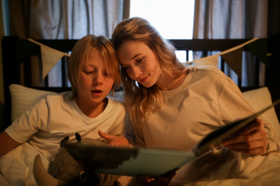 A mother and son enjoying a bedtime story together, fostering a warm family bond.