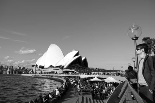Free Grayscale photo of the Sydney Opera House crowded with people enjoying a sunny day. Stock Photo