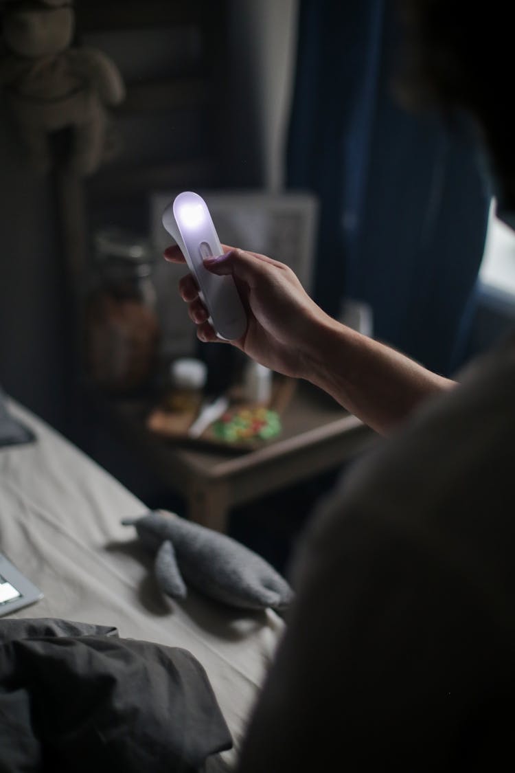 Person Using A Portable UV Disinfectant Lamp