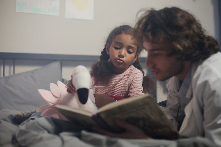 A Doctor With His Patient Reading A Book