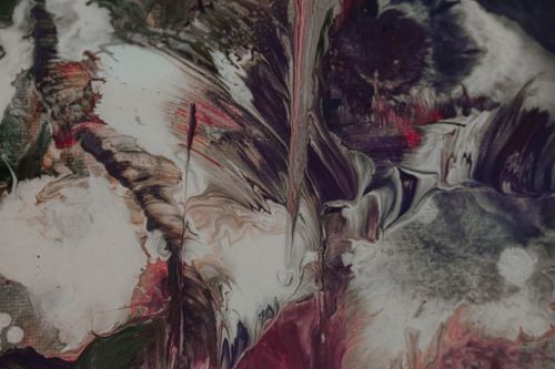 Free Abstract background representing smeared stains of spilled paint of different colors blending together during fluid art Stock Photo