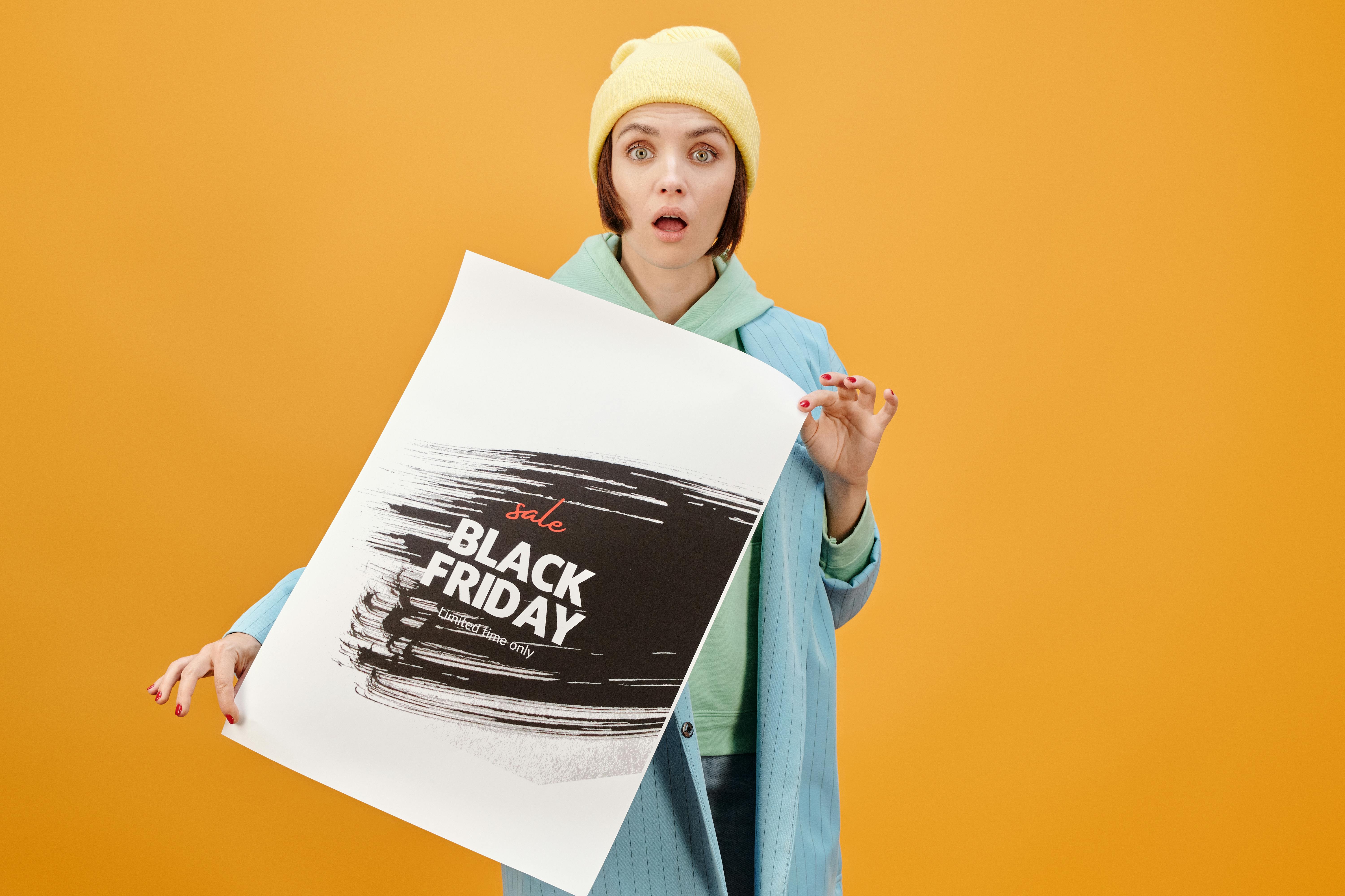 a woman holding a cardboard while looking at the camera