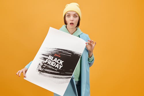 Free Woman in Yellow Knit Cap Holding White Printer Paper Stock Photo
