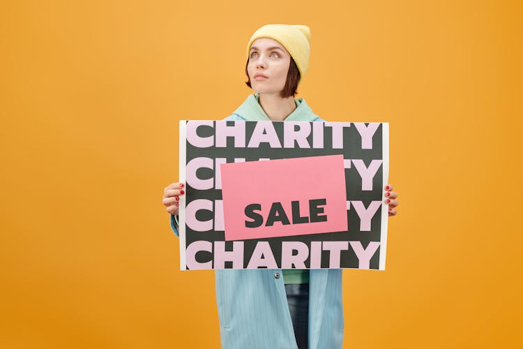 A Woman Holding A Poster