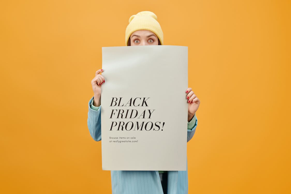 Free Woman in Blue Long Sleeve Shirt Holding White Poster Stock Photo