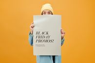 Woman in Blue Long Sleeve Shirt Holding White Poster